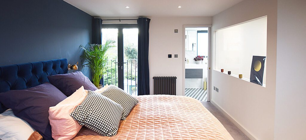 Loft room bedroom with doors to balcony and ensuite bathroom