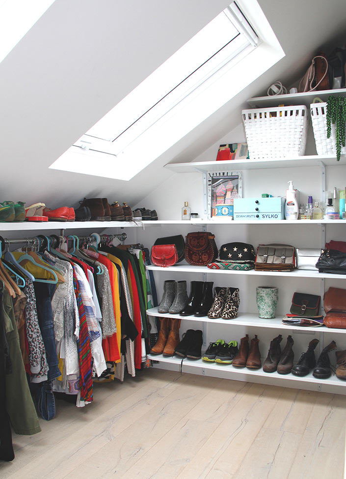 walk in wardrobe storage area under eaves built in storage in loft room with shelving and hanging rail for clothes