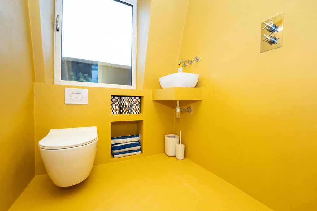 bright yellow modern bathroom in loft conversion